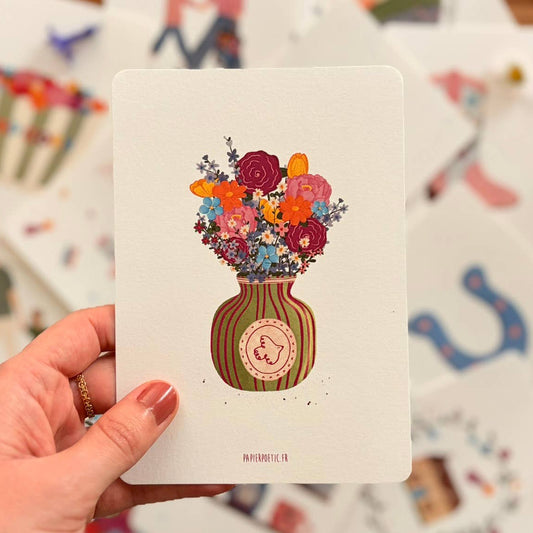 Colorful bouquet of flowers in a striped vase on a white background