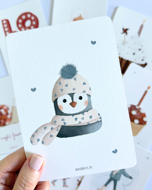 A vertical art print featuring a cute cartoon penguin wearing a beige knit hat with a gray pom-pom and a matching scarf with gray hearts, on a white background with small gray heart accents.