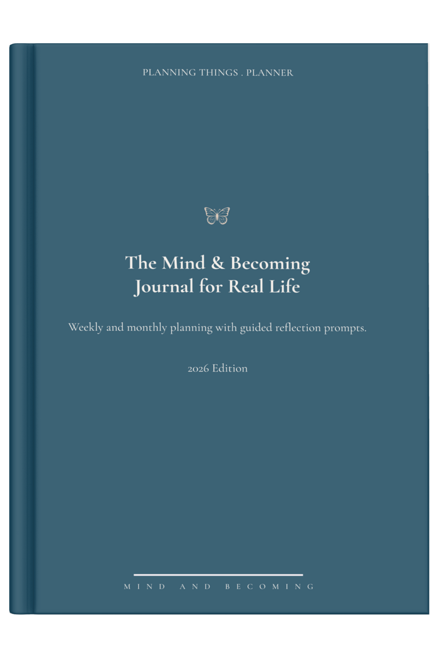 Blue journal titled 'The Mind & Becoming Journal for Real Life' on a light surface with a decorative item.