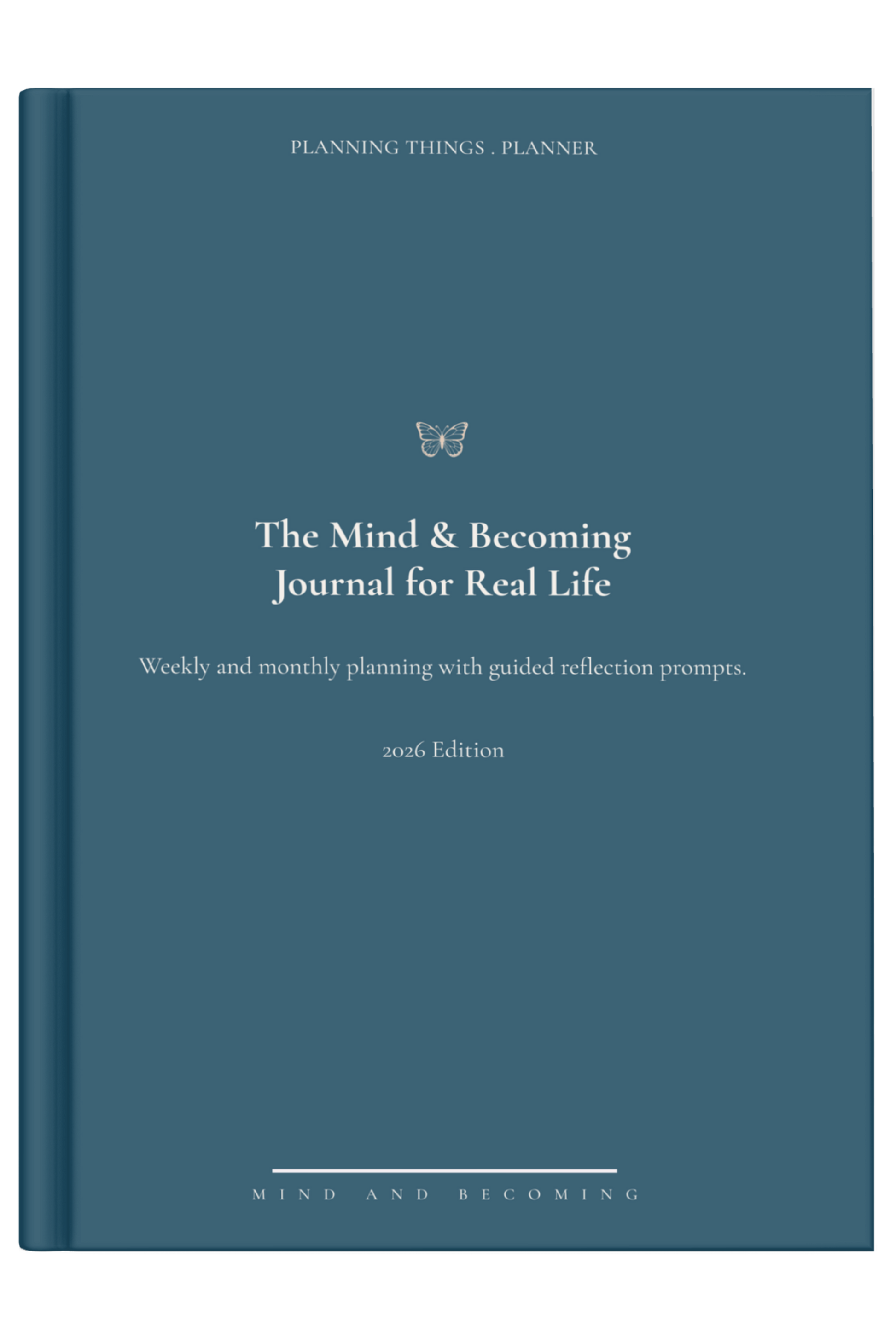 Blue journal titled 'The Mind & Becoming Journal for Real Life' on a light surface with a decorative item.