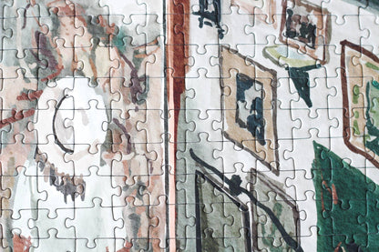 Partial puzzle with a scenic design, including trees and buildings.