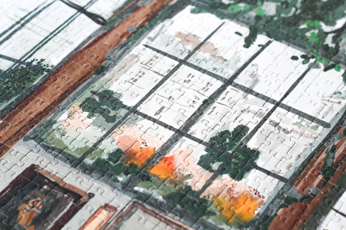 Close-up of a partially completed puzzle with a scenic design.