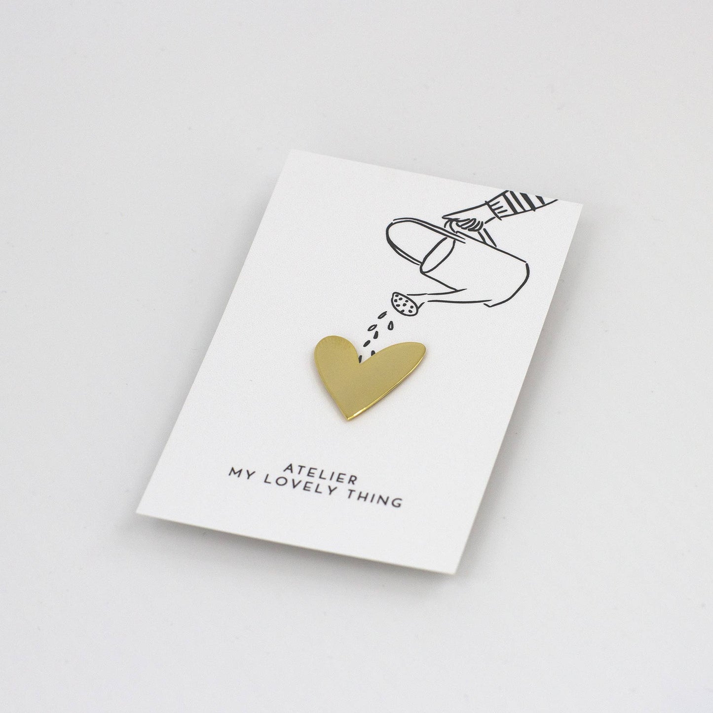 Gold heart-shaped pendant on a 'My Lovely Thing' card with a white background