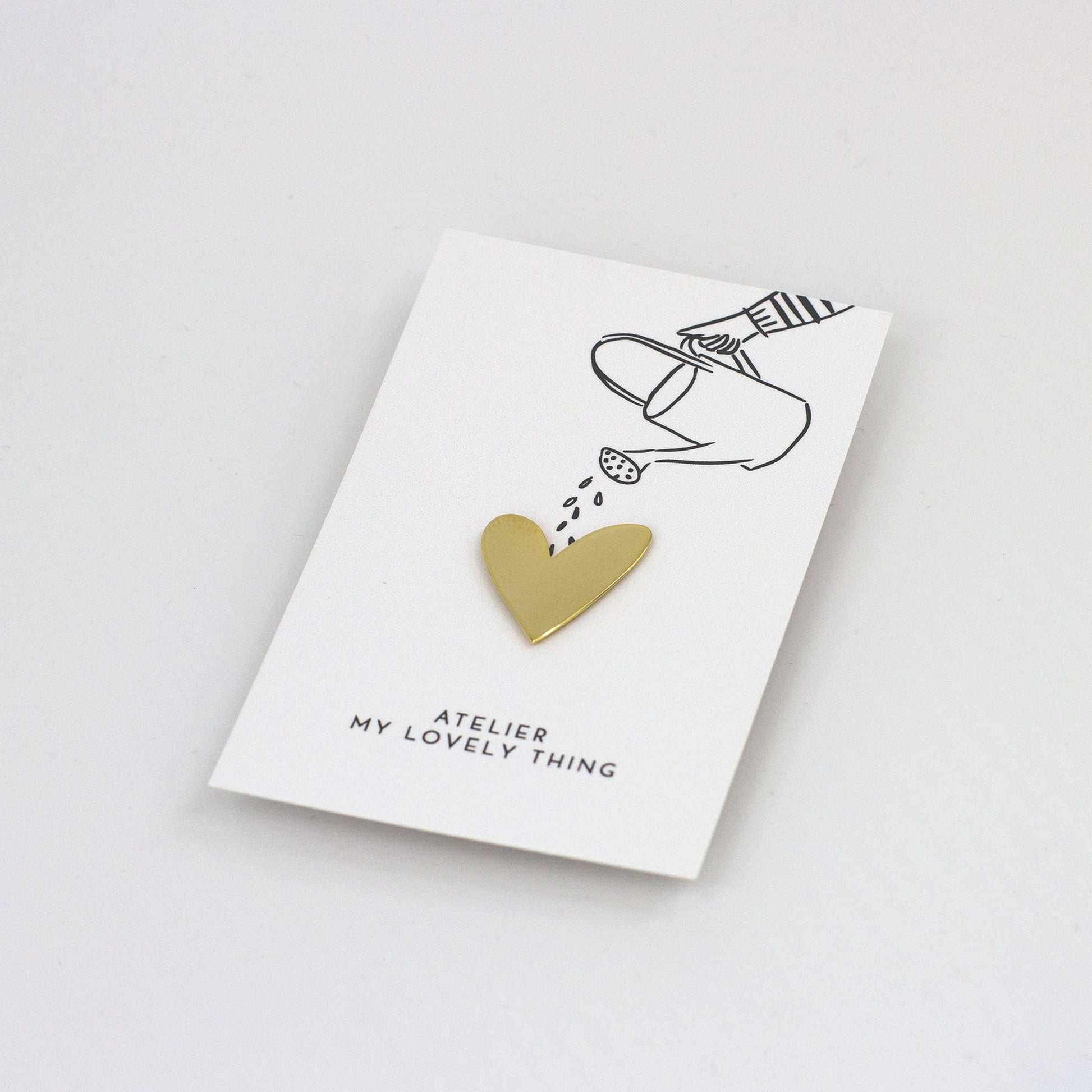 Gold heart-shaped pendant on a 'My Lovely Thing' card with a white background