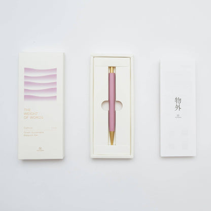 Pink pen with gold accent in a white box on a light gray background