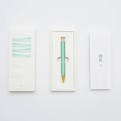 Mint green pen with gold accent in a white box on a light gray background
