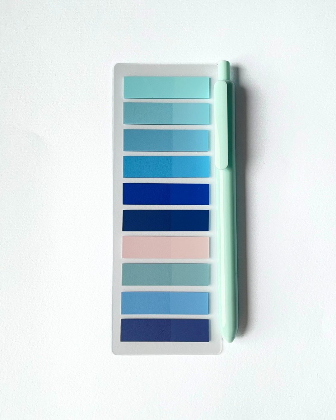 Color swatch card with blue and pink shades on a white background