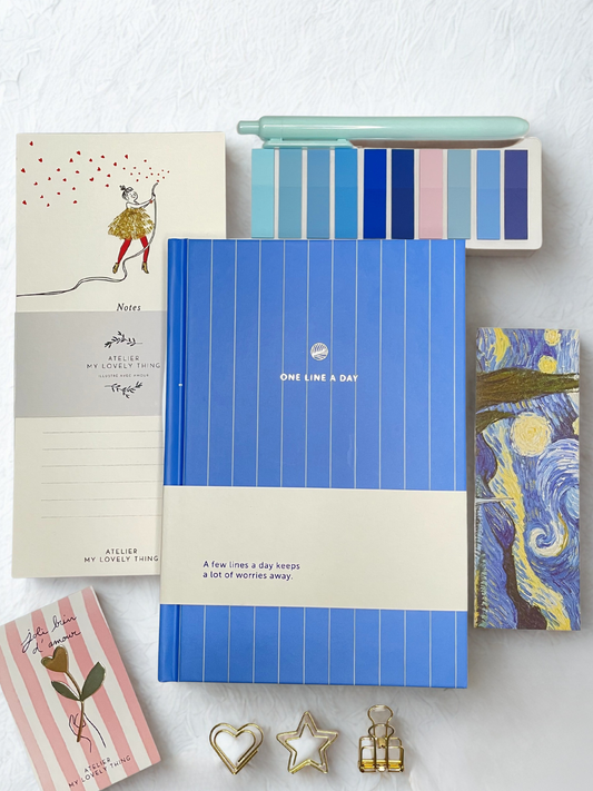 Blue notebook with notepad, sticky tabs and bookmark