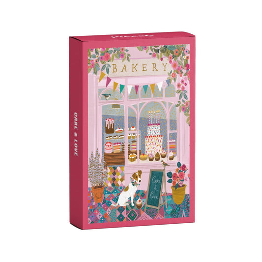 Jigsaw puzzle box with a bakery design on a pink background