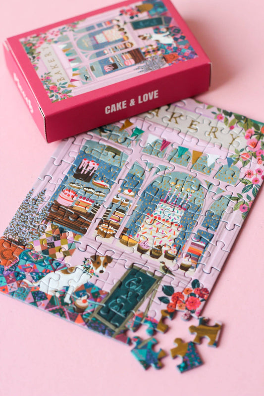 Jigsaw puzzle box with a bakery design on a pink background