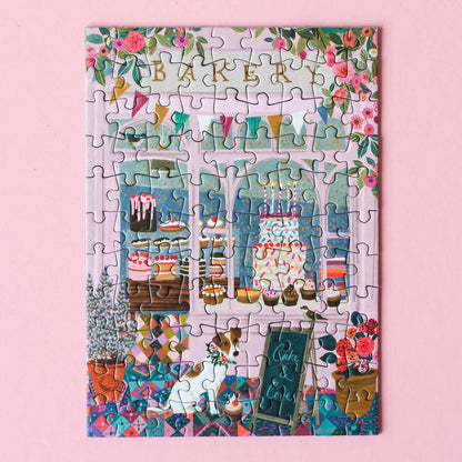 Jigsaw puzzle with a bakery-themed design on a pink background
