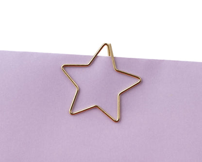 Gold star-shaped clip on a purple background