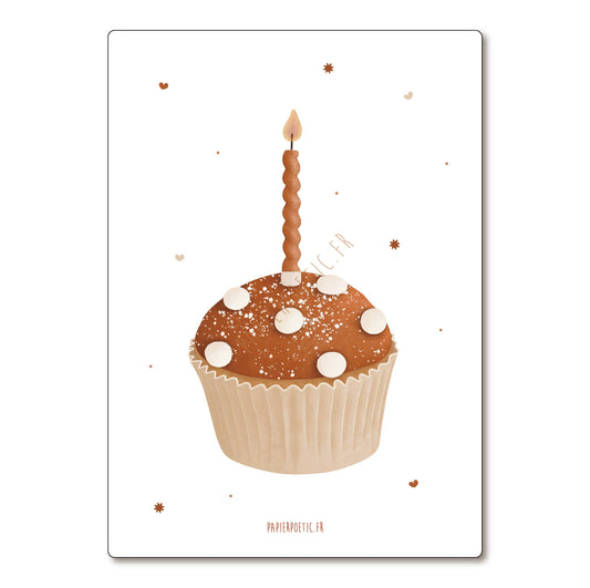 A square art print or card featuring a decorated cupcake with a single lit candle on a white background, with small scattered star-like specks and the text 'PAPIEROSTIQUE.FR' at the bottom.