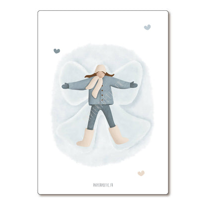 A vertical art print featuring a watercolor illustration of a child lying down in a snow angel pose, wearing a blue-gray coat, matching pants, and beige boots. The print has a white border and is displayed against a clean white background.