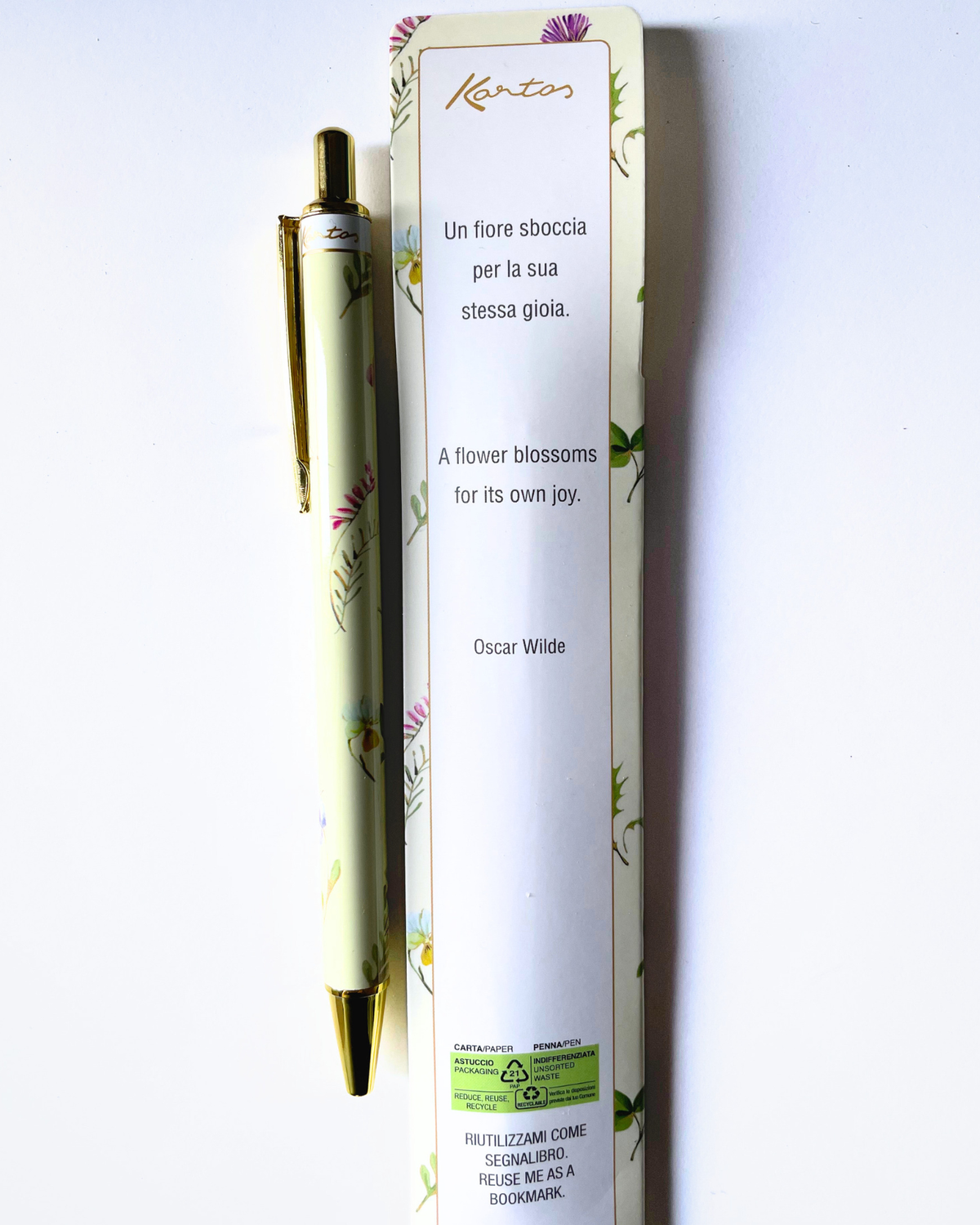 A Kencos brand ballpoint pen with a pale green floral pattern and gold accents, shown next to its white packaging box on a plain white background.