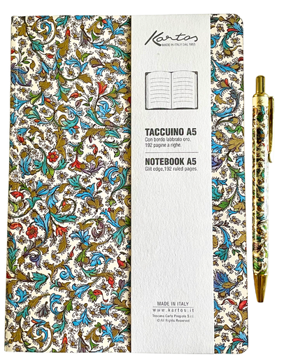 A Kanto A5 notebook with a colorful floral and scroll patterned cover, shown closed with its white paper band around the center, alongside a matching gold pen on a white background.