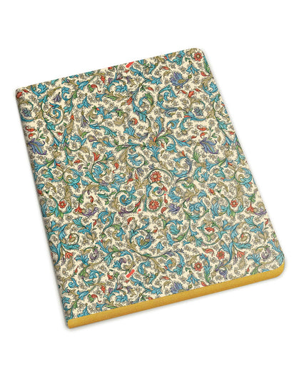 A notebook with an intricate multicolor paisley pattern on a cream cover, featuring a gold edge and gold text on the spine, shown on a plain white background.