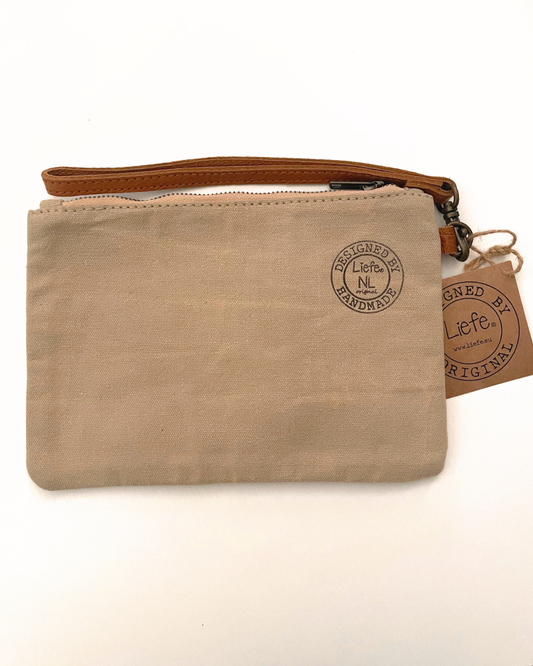A beige canvas wristlet pouch with a large brown star on the front, a brown zipper, and a brown strap, shown on a white background with a paper tag attached.
