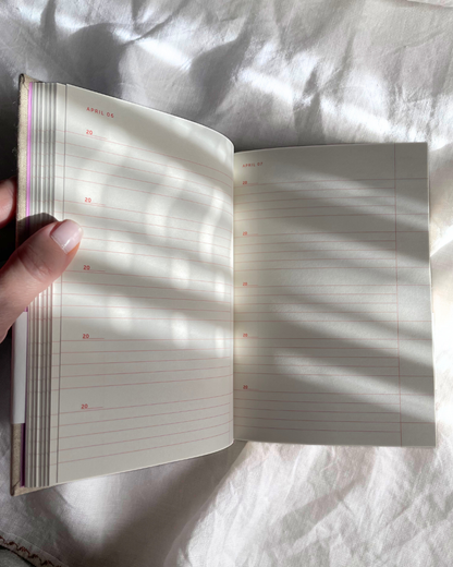 Open notebook with lined pages on a textured white surface