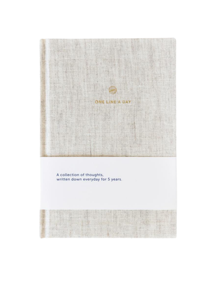Journal with textured cover and gold text on a white background