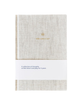 Journal with textured cover and gold text on a white background