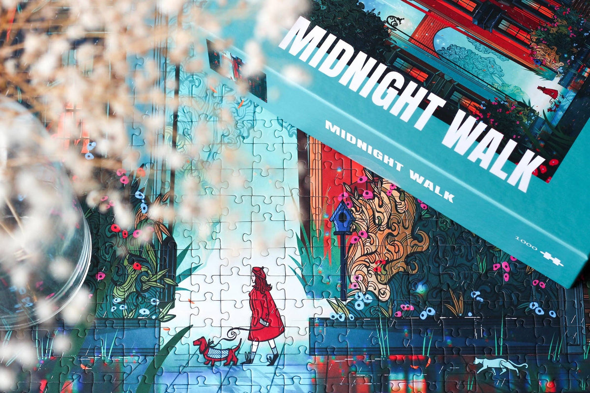 Jigsaw puzzle with 'Midnight Walk' packaging featuring a red-robed figure and decorative elements.