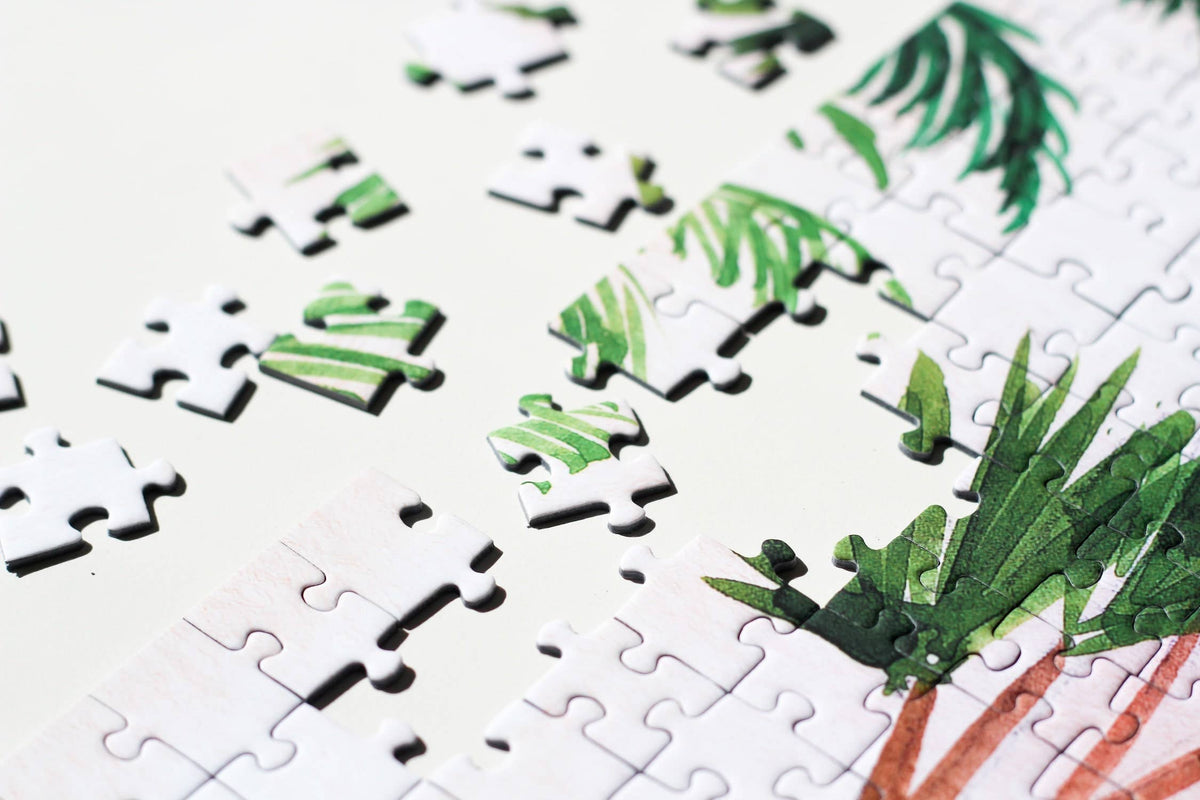 Jigsaw puzzle with green leaf design on a white background