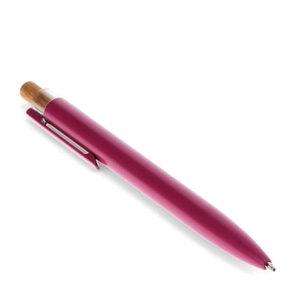 Pink pen with wooden cap on a white background