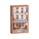 Product packaging with a scenic image of a French bistro on a clear background