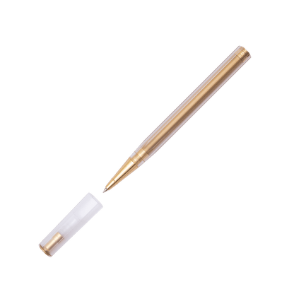 A gold-plated ballpoint pen with a transparent barrel, shown with its matching clear cap removed and placed beside it on a solid white background.