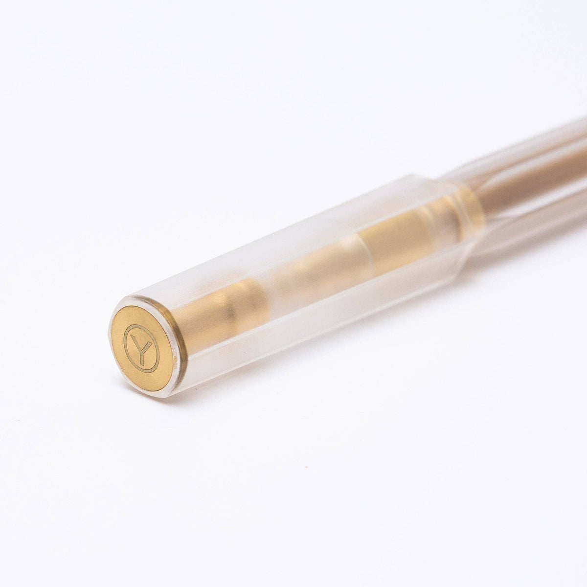 Clear pen with gold accents on a white background