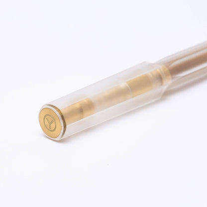 Clear pen with gold accents on a white background