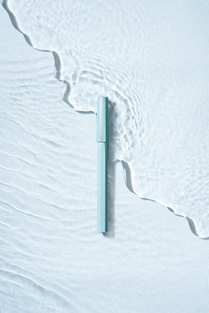 Light blue pen on a textured white surface