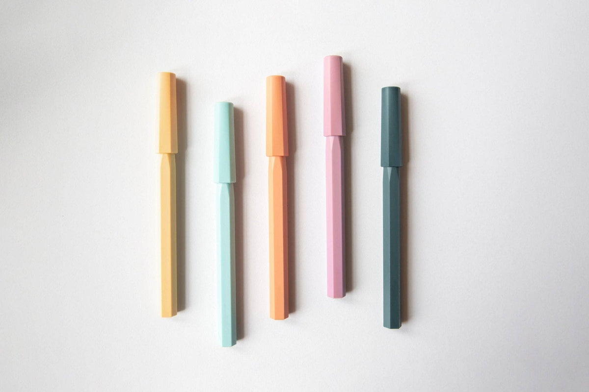 Five colorful pens on a white background