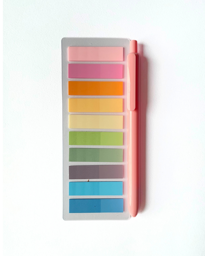 Set of colorful sticky notes with a pen on a white background