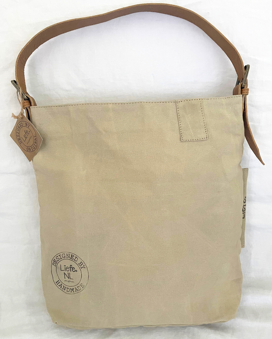 A beige canvas shoulder bag with a brown leather strap and a circular 'Life is Beautiful' logo printed on the front, displayed against a white background.