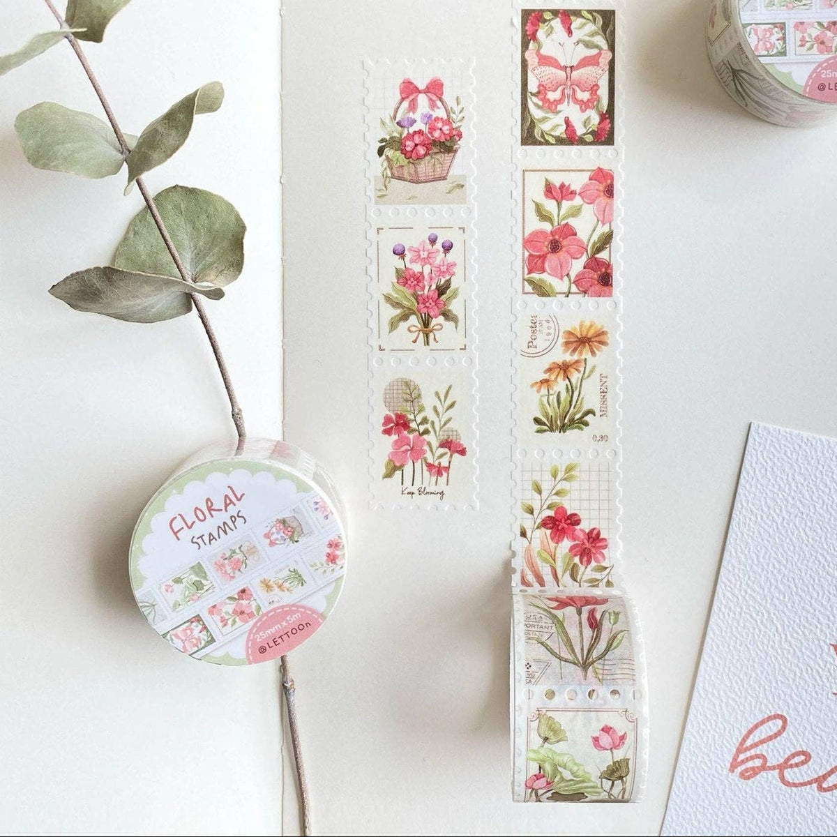 Floral-themed washi tape with a decorative container on a white surface.
