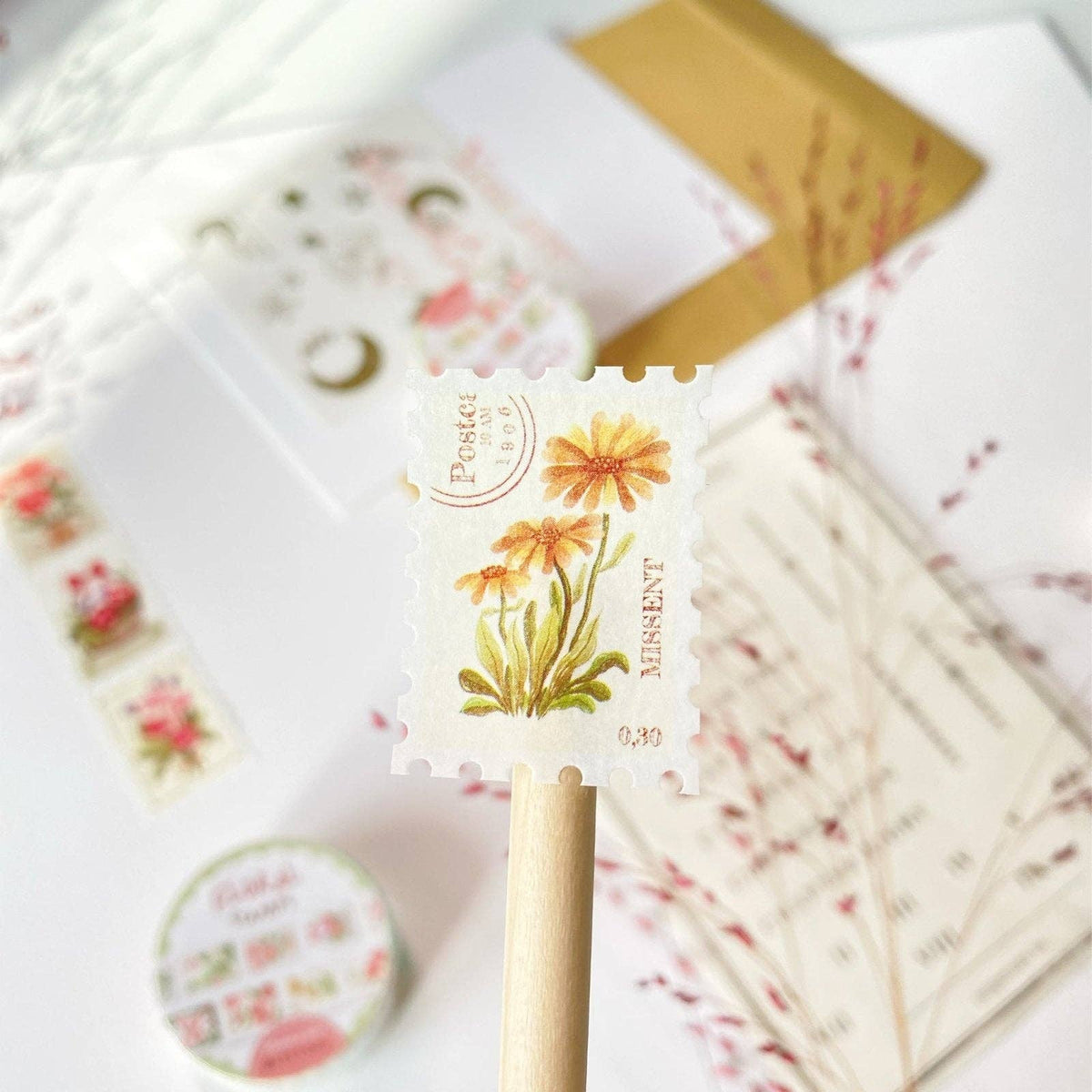 Decorative paper clips with floral designs on a white surface