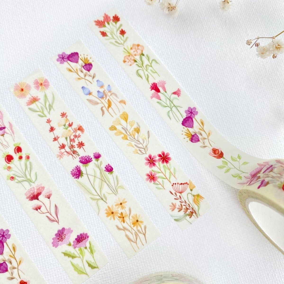 Floral washi tape with a pair of scissors on a white background