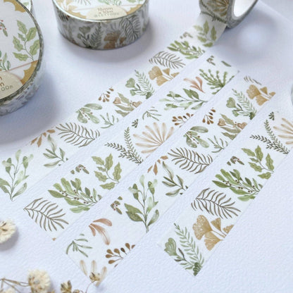 Set of washi tape rolls with leaf patterns on a white background
