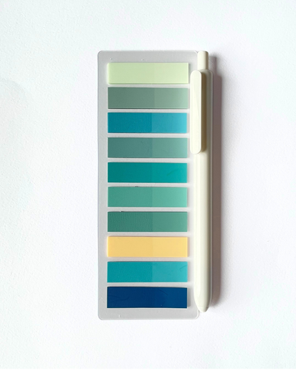 Color swatch chart with a pen on a white background
