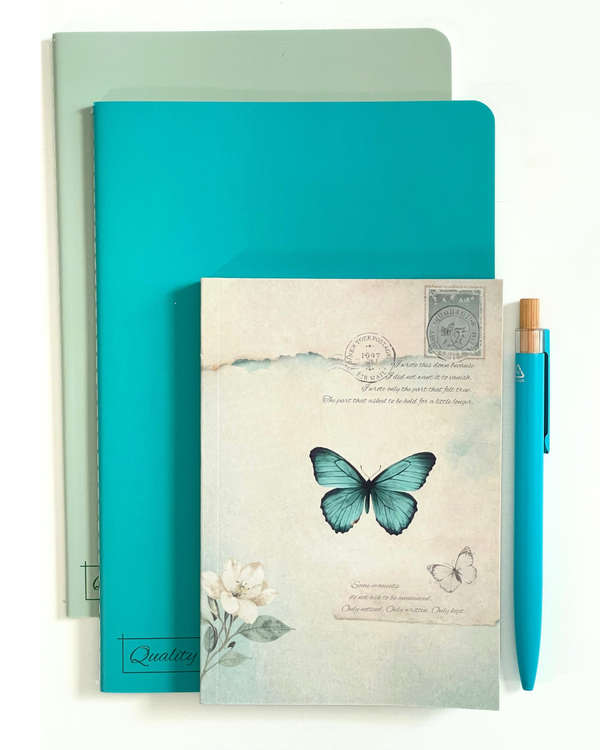 A stationery set featuring a mint green notebook, a turquoise notebook, a vintage-style butterfly notebook cover, and a matching turquoise pen on a white background.