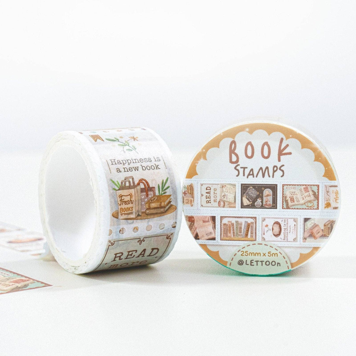 Two rolls of decorative washi tape featuring vintage book-themed illustrations and text, displayed on a clean white background. One roll is standing upright showing printed designs, and the other is lying down showing the circular patterned backing with the text 'BOOK STAMPS'.