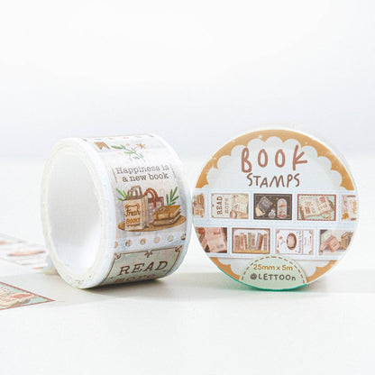 Two rolls of decorative washi tape featuring vintage book-themed illustrations and text, displayed on a clean white background. One roll is standing upright showing printed designs, and the other is lying down showing the circular patterned backing with the text 'BOOK STAMPS'.