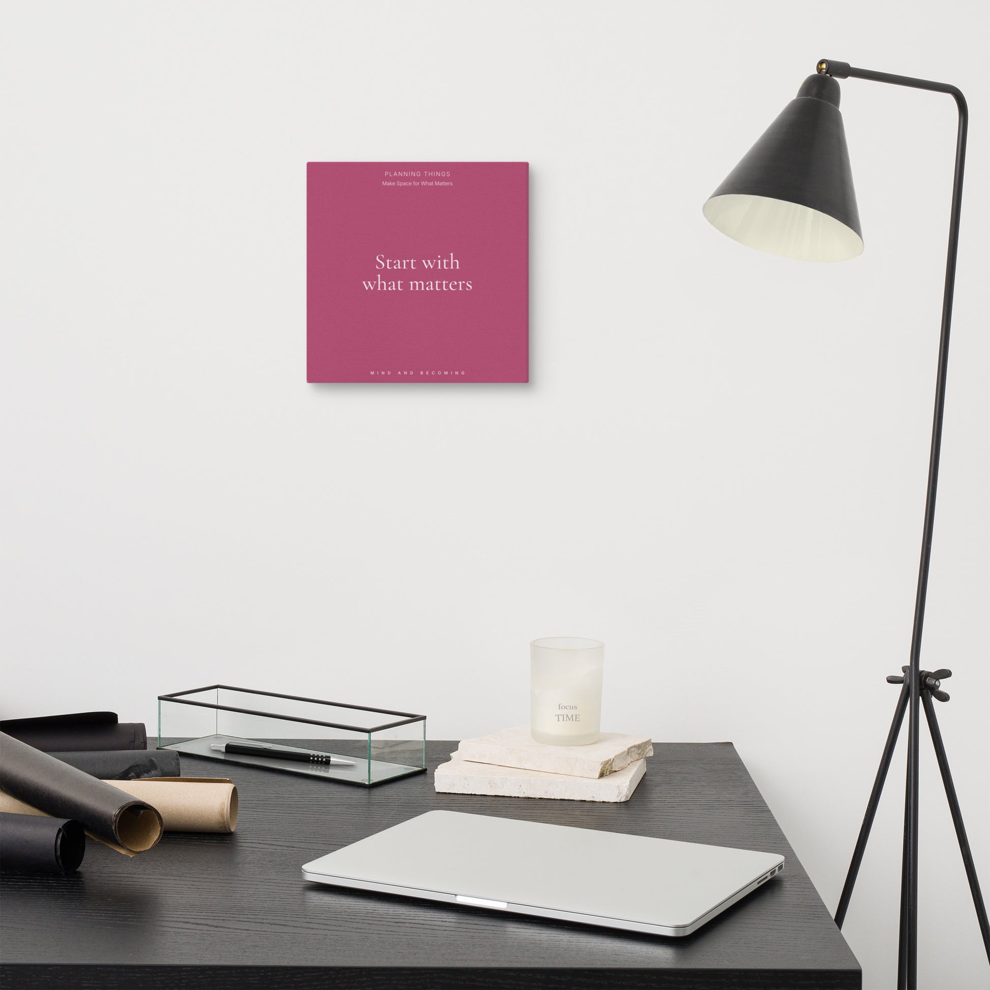 Modern office desk with motivational poster, lamp, and decor items.