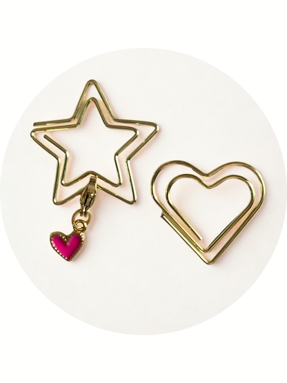 Gold star and heart-shaped earrings on a white background
