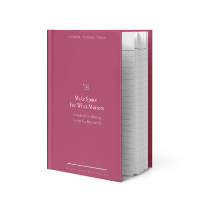 Pink notebook with text on a white background