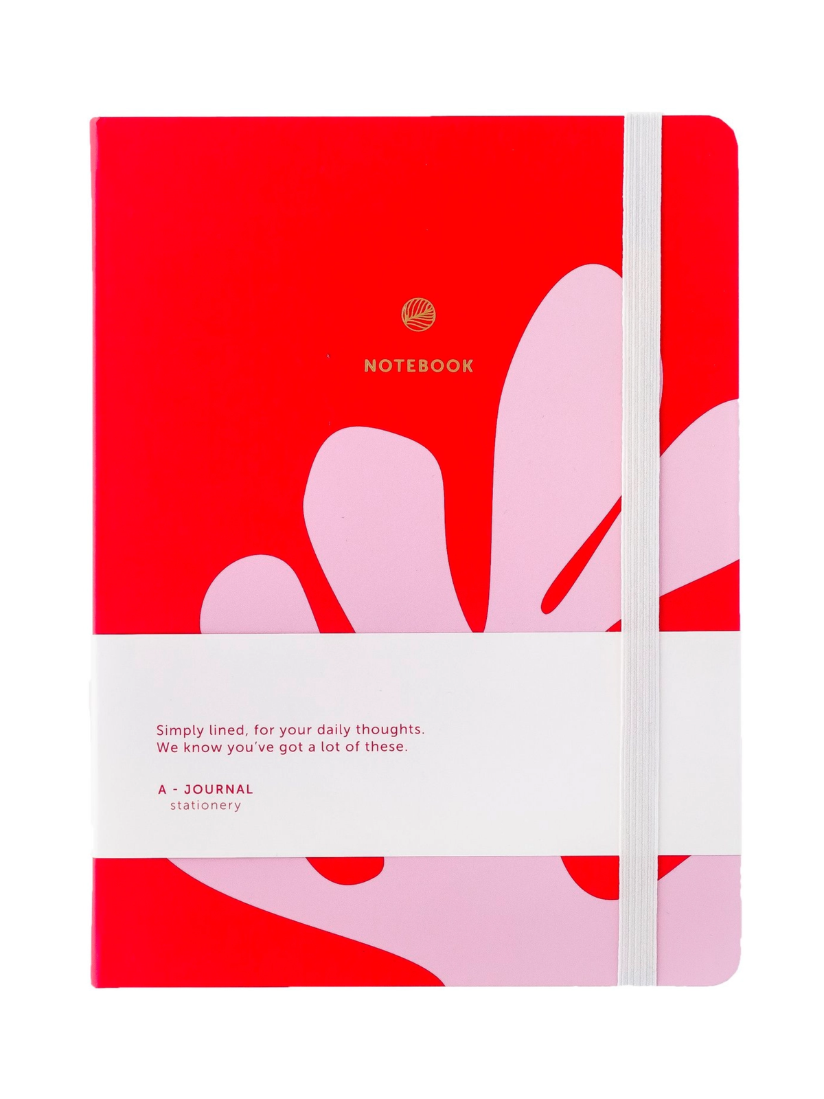 A red hardcover notebook with a white elastic closure band and a white paper wrap around the middle, featuring abstract pink shapes and the text 'A JOURNAL' and 'stationery'.