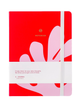 A red hardcover notebook with a white elastic closure band and a white paper wrap around the middle, featuring abstract pink shapes and the text 'A JOURNAL' and 'stationery'.
