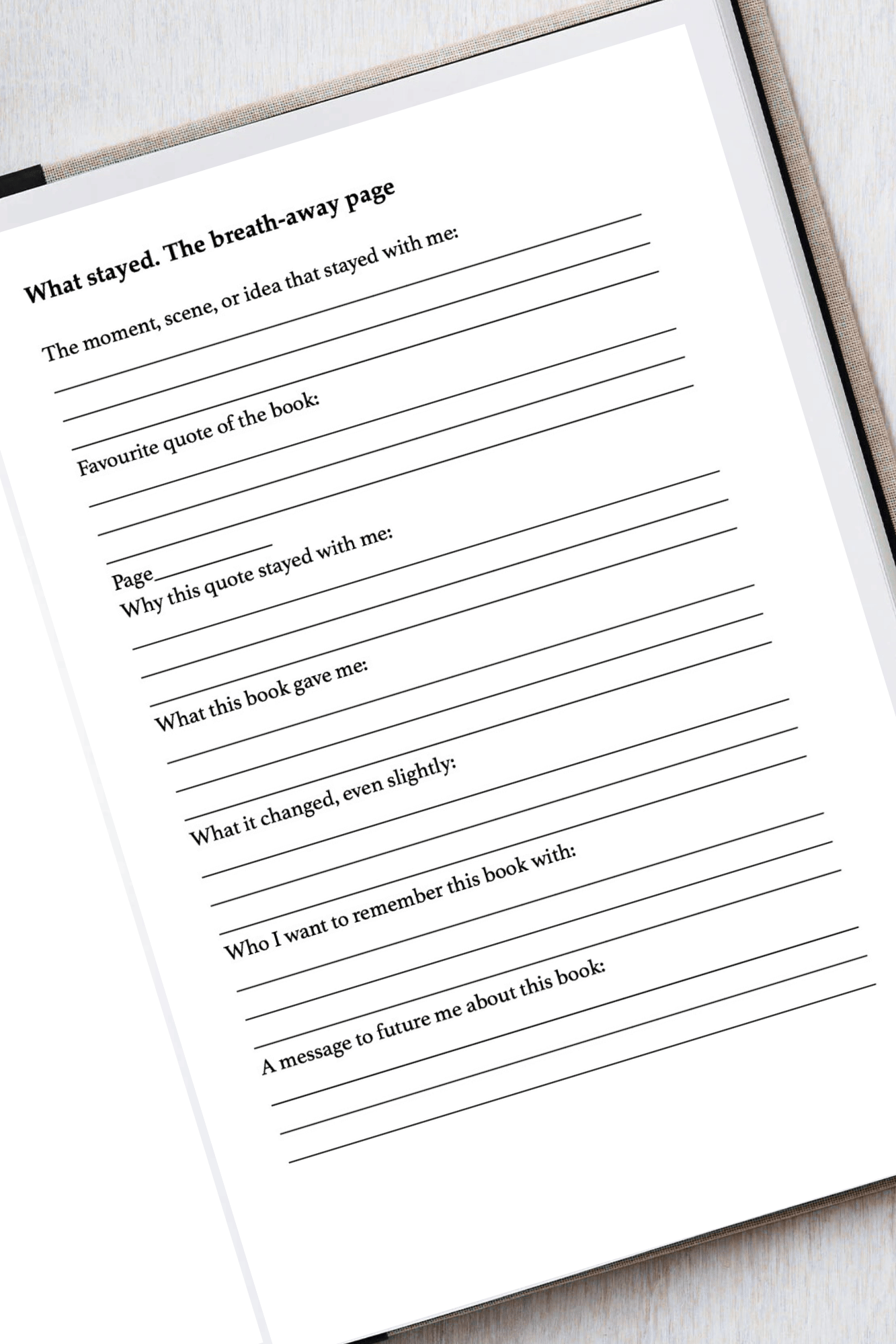 Blank page with text prompts for a book review or reflection on a white surface